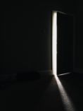 Dark room with door slightly opened